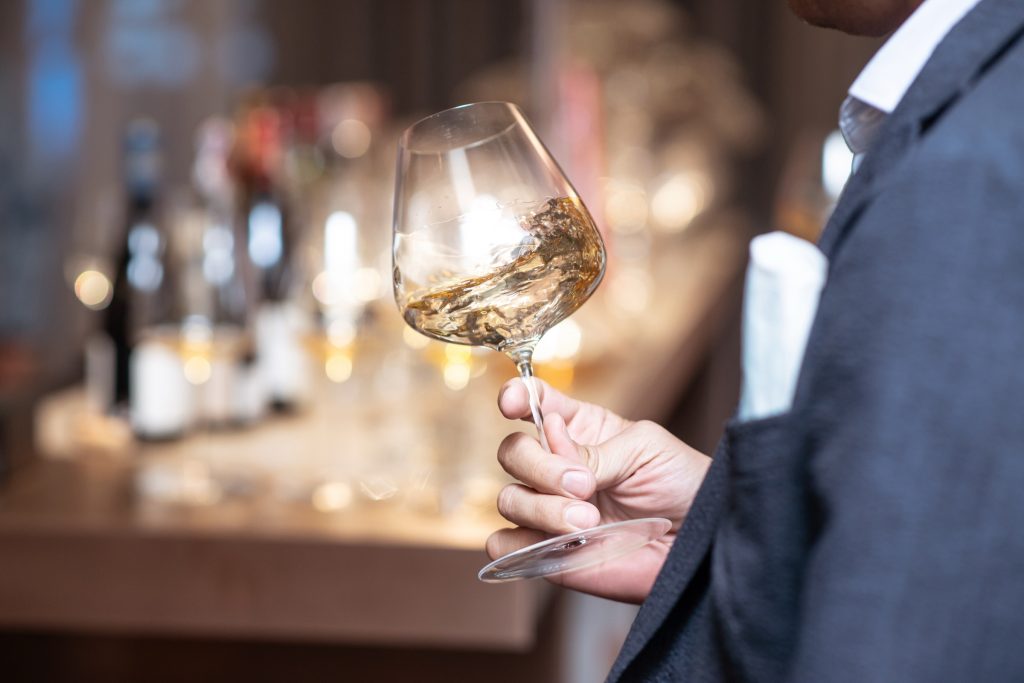 Sommelier swirling a glass of red wine at Chandlers Steakhouse, Boise